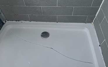 Shower tray repair for leaks and damage, ensuring proper function.